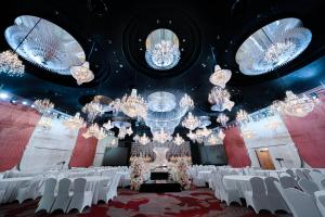a banquet hall with white chairs and chandeliers at Four Points by Sheraton Hangzhou, Binjiang in Hangzhou +41 photos