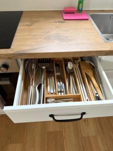 a drawer full of utensils in a kitchen counter at Ruhig wohnen in Hüttblek in Hüttblek