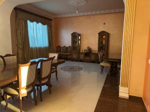 a dining room with a table and a piano at Dom in Aygavan