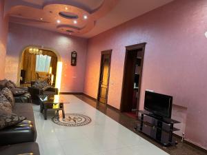 a living room with a couch and a tv at Dom in Aygavan