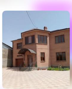 a large brick house with a driveway in front of it at Dom in Aygavan