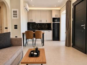 a living room with a couch and a table at Amara 2 bedrooms apartment - Alykanas in Alikanas