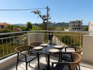 a table and chairs on a balcony with a view at Amara 2 bedrooms apartment - Alykanas in Alikanas