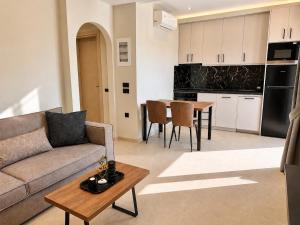 a living room with a couch and a table at Amara 2 bedrooms apartment - Alykanas in Alikanas +6 photos