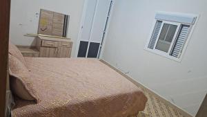 a small bedroom with a bed and a window at La Casa de Madrid in Larache