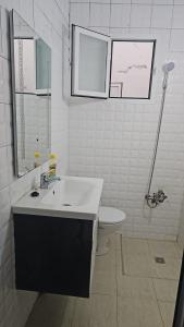 a white bathroom with a sink and a toilet at La Casa de Madrid in Larache +1 photo