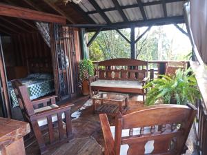 a porch of a house with wooden benches at Paz y Tranquilidad in Marsella