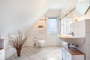 a bathroom with a sink and a toilet at Haus 29 in Röbel +17 photos