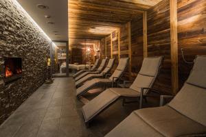 a row of chairs in a room with a fireplace at Hotel Bristol in Zermatt