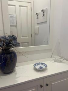 a blue and white vase on a counter in a bathroom at Dimora Patrizia in Scario +107 photos