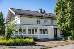 ein weißes Haus mit grauem Dach in der Unterkunft Hoffmanns in Burgkirchen an der Alz