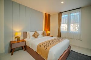 a bedroom with a large bed and a window at Anandani Suites in Canggu +66 photos
