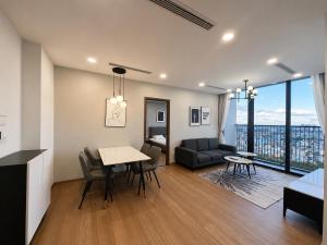 a living room with a table and a couch at Eco Green Apartment Residence District 7 in Ho Chi Minh City