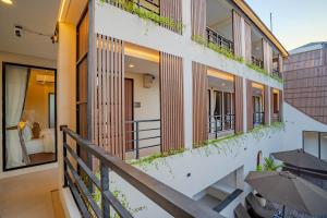 a view of the balcony of a building with umbrellas at Anandani Suites in Canggu