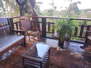 a porch with a bench and a table and a plant at Paz y Tranquilidad in Marsella