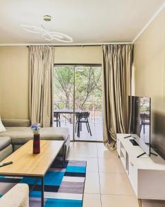 a living room with a couch and a table at Zion on Mayfair in Cape Town