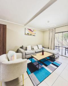 a living room with a couch and a table and chairs at Zion on Mayfair in Cape Town