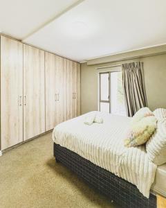 a bedroom with a large bed and a window at Zion on Mayfair in Cape Town