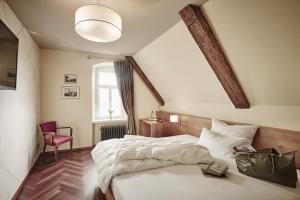 a hotel room with two beds and a window at Hotel Schloss Freudental in Allensbach