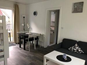 a living room with a couch and a table at FEWO Kliff Watt Nr.4 in Cuxhaven
