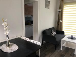 a living room with a black table and a couch at FEWO Kliff Watt Nr.4 in Cuxhaven