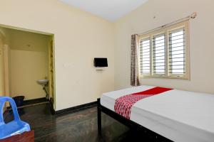 a bedroom with a bed and a window at SPOT ON Ganesh in Kaglipur