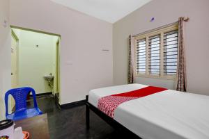 a bedroom with a white bed and a window at SPOT ON Ganesh in Kaglipur