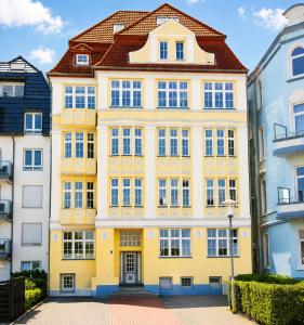 a yellow building with a red roof at Am Seedeich 7 SE10 Seesicht in Cuxhaven