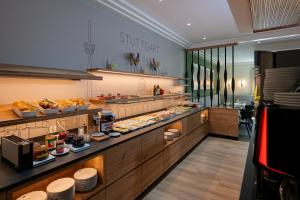 a buffet line in a restaurant with food on display at Hotel Azenberg in Stuttgart