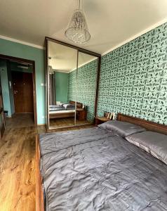 a bedroom with a large bed and a mirror at The Third Six in Świnoujście