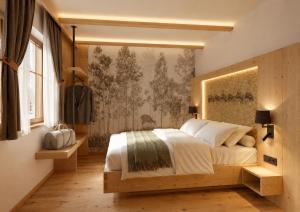 a bedroom with a large bed and a wall mural at Das Eppensteiner in Navis