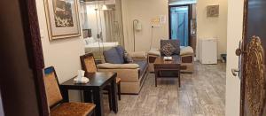 a living room with couches and chairs and a table at شاليهات رميس in Abha