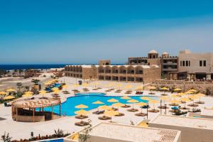 a resort with a pool with umbrellas and chairs at UTOPIA Blue Resort in Quseir