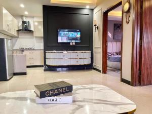 a chanel room with a television and a table at 2BHK Apartment Perfect for Families & Groups in Rawalpindi