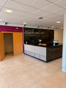 a lobby with a helixotechnology counter in a building at Hotel del Vino in Cariñena