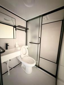 a bathroom with a toilet and a sink and a shower at Umbrella tree เต้ทน์ in Nathon Bay