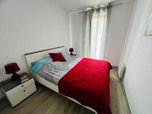 a bedroom with a red bed and a window at Łebska ostoja in Żarnowska +16 photos