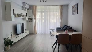 a living room with a couch and a table with chairs at AMA Home in Sebeş