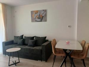 a living room with a couch and a table at AMA Home in Sebeş