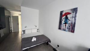 a room with a bed with a painting on the wall at Bamboo Beach 358 in Ts'ikhisdziri