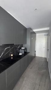 a kitchen with black counter tops and a hallway at Bamboo Beach 358 in Ts'ikhisdziri +10 photos