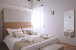 a bedroom with a large bed with towels on it at Locanda la Rocca Residenza d'Epoca in Fossombrone +54 photos