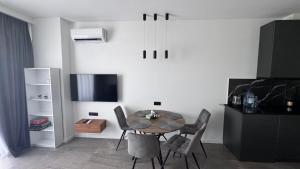 a dining room with a table and chairs at Bamboo Beach 358 in Ts'ikhisdziri