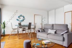 a living room with a couch and a table at Les 2 tours La Rochelle in La Rochelle