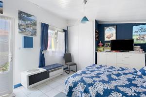 a bedroom with a bed and a desk and a tv at Chambre d'hôte Lajarrieleduc in La Jarrie
