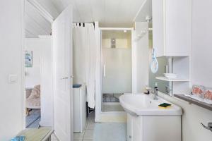 a white bathroom with a sink and a toilet at Chambre d'hôte Lajarrieleduc in La Jarrie