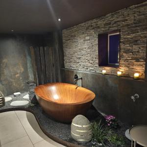 a wooden tub sitting on a counter in a bathroom at ALPENGARTEN EIGENTHAL - Private Wellness Retreat in Eigenthal +39 photos