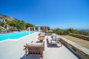 a villa with a swimming pool and a resort at Primadonna Luxury Villas in Mikonos