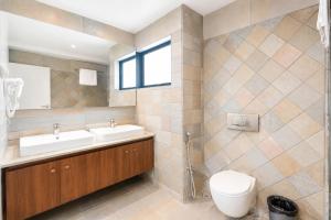 a bathroom with two sinks and a toilet at Viz Park Hotel - Business Hotel & Banquet, GIDC Anand in Anand +35 photos