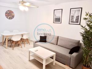 a living room with a couch and a table at Beach Formentor salou in Salou +30 photos